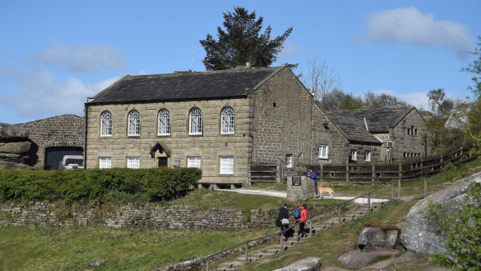 Visitors walking near the National Trust visitor centre and shop at Brimham Rocks, North Yorkshire